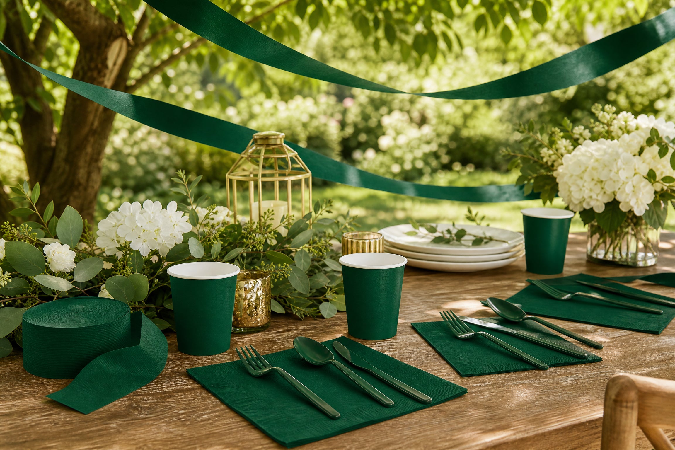 Hunter green party tableware arranged for an elegant garden party