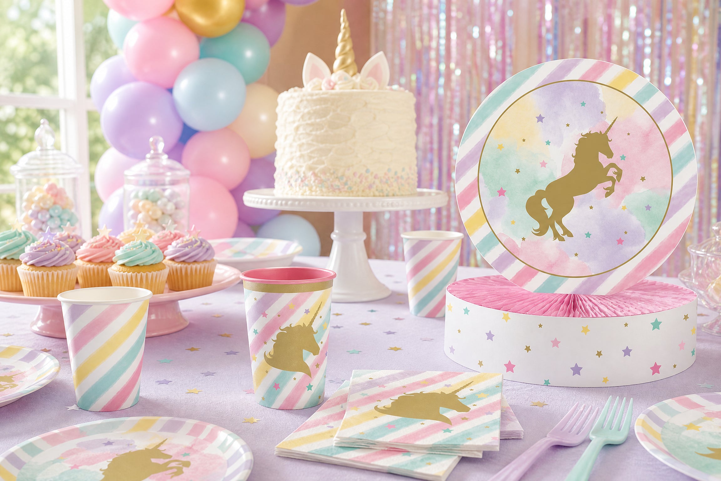 Pastel unicorn kids birthday party table with themed decorations